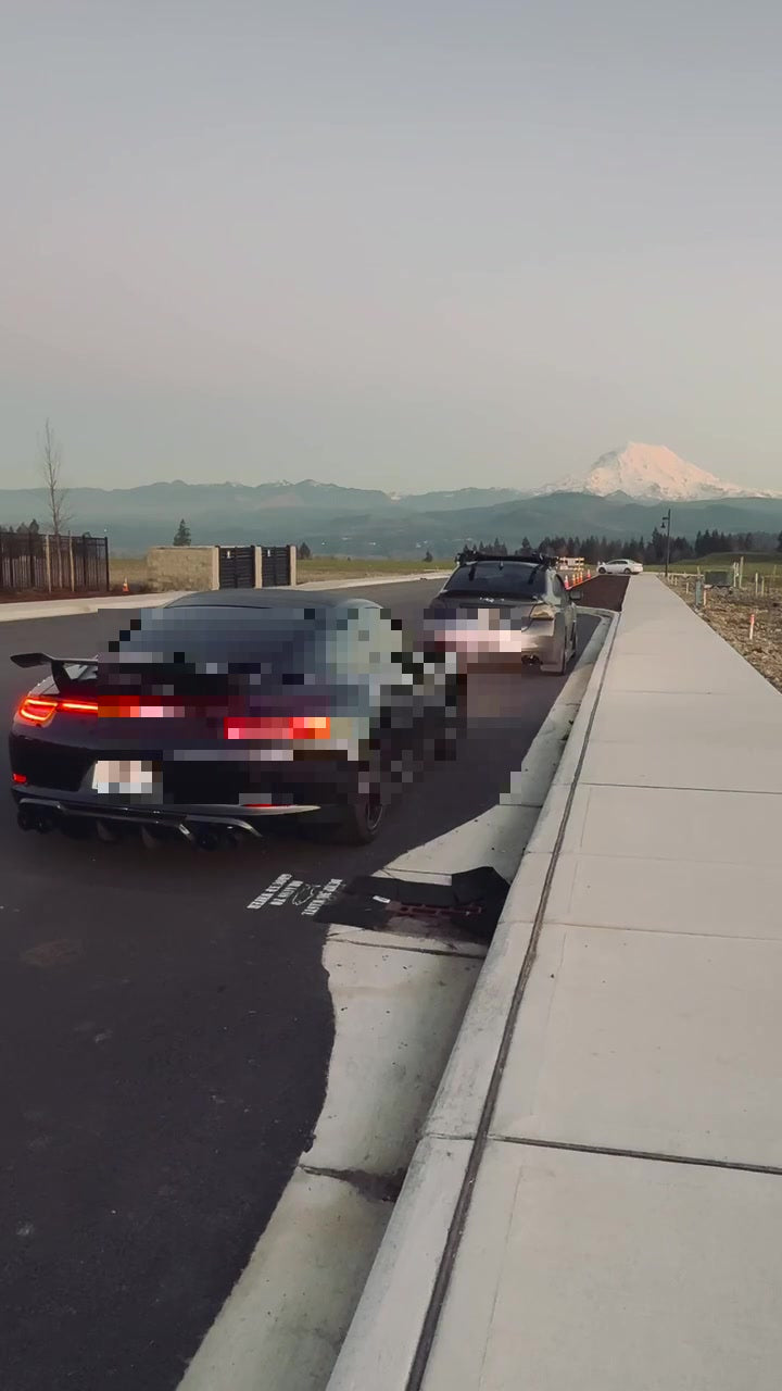 Porsche 991.1 Carrera 4S rear, titanium valved cat-back, US license plate pixelated