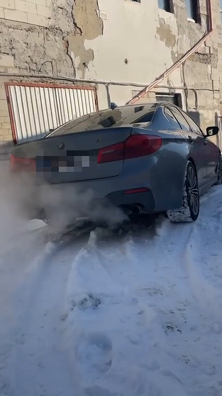 BMW M550i G30 rear three-quarter, SUS304 valved catback fitted, number plate pixelated